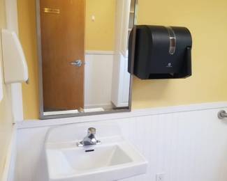 Sink; commercial mirror; paper towel dispenser