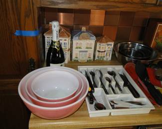 Pyrex bowls in pink, three house canister set, and some silverware