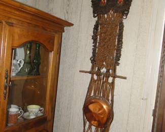 It is a little dusty, but macrame owl holding cooper pans