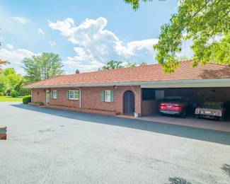 Two car carport and paved circle drive