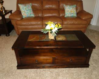 And in front of the leather sofa, we have this tile topped coffee table with storage drawers. Why do they call it a coffee table?