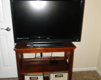 TV, stand and some storage boxes