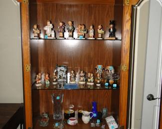 Hummels, in a cabinet that is also for sale