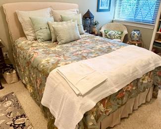 Queen bed with upholstered headboard.