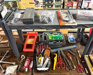 Mixed tool lot: includes hand tools (pliers, cutters, wrenches), small parts organizer, and miscellaneous boxed/packaged hardware items.