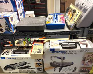 A Dremel Moto-Saw power tool kit, a Dremel 231 Rotary Tool Compact Mountable Wood Shaper and Router Table, a  a Dremel Moto-Saw (model MS20-01) variable-speed scroll saw kit. And a a Dremel SM20-02 Saw-Max tool kit