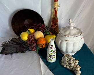 Lot 22: Still-life arrangement with ceramic tureen, fruit basket, and decorative bottles