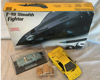 Lot 55: F-19 Stealth Fighter model kit with Buick Riviera diecast and wooden wagon