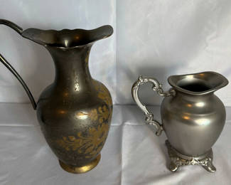 Lot 20: Two decorative metal pitchers with floral motifs