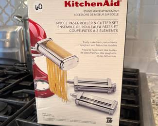 L66 - $60. KitchenSid Stand Mixer Attachment. 3 piece pasta roller & cutter set. Looks new in box.