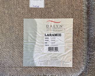 L15 - $95. Dalyn Rug Company. "Laramie" 9' x 13'. AS IS. Rug is sun faded as seen in the photos. The darker color is where the bed was - it does not vacuum to be the same color.