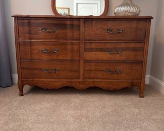 L16 - $125. Bassett Furniture Dresser with Mirror. Measures 52.5" wide x 17.75" deep x 31.75" tall. Mirror is 26" x 37". Mirror is NOT attached and is wall hanging. All drawers slide easily. Minor surface wear / marks.