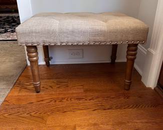 L28 - $25. Small upholstered entry bench. Measures 26" x 18" x 17" tall. Very good condition. Has adjustable feet.