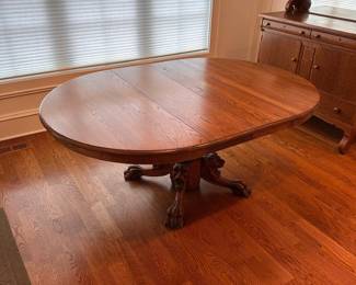 L10 - $350. Round or Oval Solid Wood Dining Table. Has carved lions on the base. Measures 48" round x 29.5" tall. 2 leaves are 11.5" each. I believe this is Hastings Table Co. or RJ Horner. Both made similar tables in the late 1800s. Table top isn't terrible but has a few marks here and there. Sturdy & very useable as is!