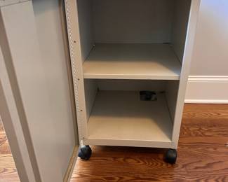 L72 - $20. Rolling Metal Cabinet. Measures 16" x 19" deep x 28.5" tall.