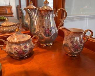 L23 - $35. Small Tea Set from "Sterling China". Teapot, creamer & sugar & 5 cups/saucers.