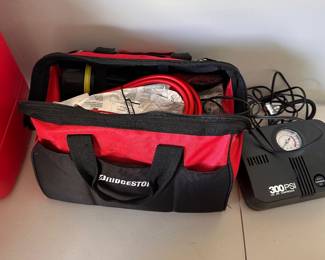 L100 - $15. Bridgestone Auto Emergency Kit. Jumper Cables, air pump & other accessories.