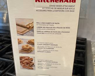 L66 - $60. KitchenSid Stand Mixer Attachment. 3 piece pasta roller & cutter set. Looks new in box.
