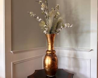 L22 - $10. Glass Vase with floral display. Measures 23.5" tall.
