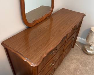 L16 - $125. Bassett Furniture Dresser with Mirror. Measures 52.5" wide x 17.75" deep x 31.75" tall. Mirror is 26" x 37". Mirror is NOT attached and is wall hanging. All drawers slide easily. Minor surface wear / marks.