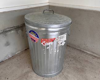 L91 - $15. Steel trash can with lid - looks like it stored dog or bird food.