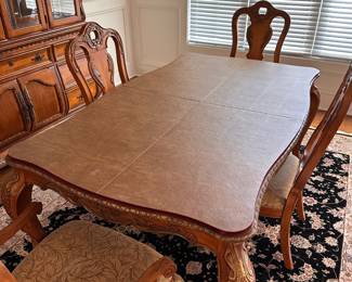 L2 - $375. Dining Table with 2 Captains Chairs, 4 regular chairs. Measures 6' long x 44" wide x 30" tall. 2 Leaves - 18" each. (Table can be 9' long full extended).