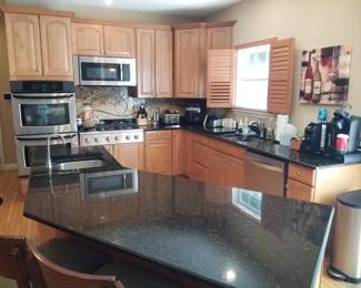 Handsome kitchen with self closing drawers & cabinets; large kitchen island
