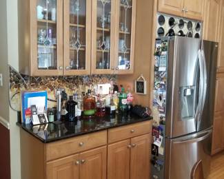Kitchn cabinetry detail - note custom wine rack above fridge