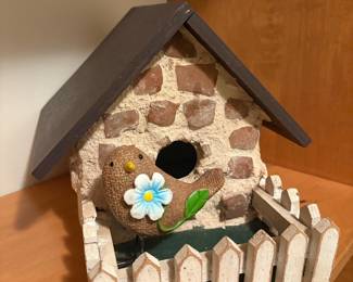 Decorative Birdhouse with Stone Facade and Picket Fence