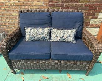 Outdoor wicker loveseat with cushions