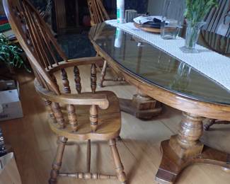 OAK SOLID TABLE AND CAPTAIN CHAIRS W/ EXTRA LEAVES & A GLASS TOP
