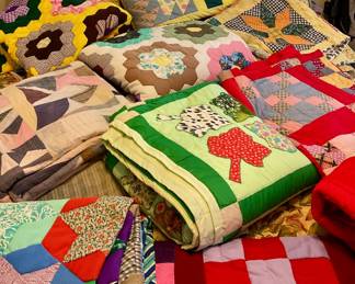 At least a dozen hand made quilts