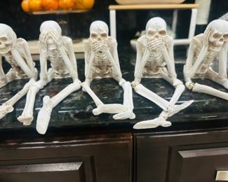 Five-Piece Skeleton Wisdom Figurine Set β 'See No Evil, Hear No Evil, Speak No Evil' Style. Detailed bone-tone resin skeletons in seated poses