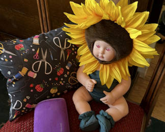 Lot 19: Baby Doll with Sunflower Headpiece, Decorative Pillow, and Eyeglasses Case