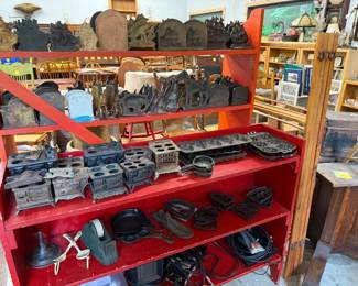 Cast iron toy stoves, iron trivets, scotch tape dispenser, muffin and cornbread pans..