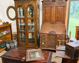 Against wall: On left, tall Walnut beveled glass all sides china cabinet, 36"w by 16"d by 82" t. ; Secretary/bookcase, walnut, dropfront, 36"w by 85"t by 21" deep. Nice cedar chests in front of those cabinets.