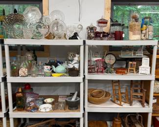 Misc items including a stack of wooden bowls, doll chairs, stereoptican and cards, children's disnes and more.