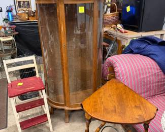 Curved glass china cabinet. 32" w by 63" t by 13" d. Oak with real glass. Three shelves are resting on top.