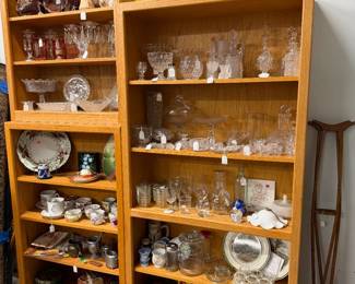 Glassware and china items. Some toys on bottom shelf.