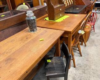 Many tables, desks, chairs and lots of glassware.