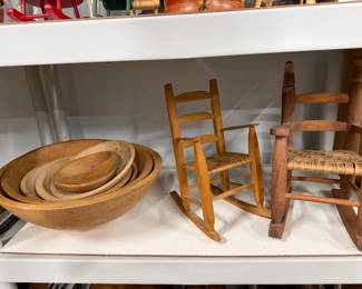 Stack of misc wooden bowls and doll chairs.