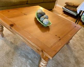 large square coffee table or puzzle/game playing table with cushions surrounding it 