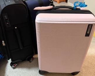 pink American Tourister hard side, spinner