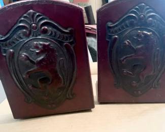 These vintage Florentine bookends feature a deeply embossed lion crest shield on dark brown leather..
