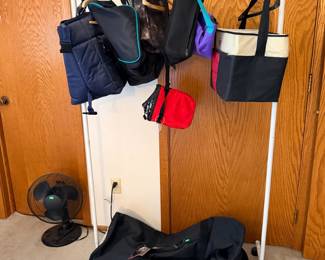 Duffle bag and coolers, clothes rack, fan