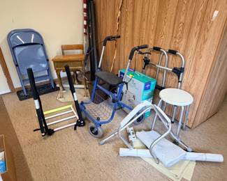 folding chairs, walkers, raised toilet seat, toilet seat handles, antique school desk, walking stick, flag