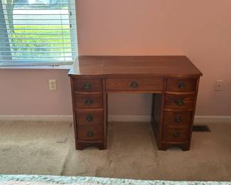 $50.00  vintage mahogany serpentine-front knee-hole desk with brass ring pulls, likely mid-20th century traditional/Hepplewhite style. Really classic and well-made.  Solid wood  construction,Vintage/antique style All drawers functional Brass hardware intact  Condition: [Very good- may have a few scratches]  Dimensions: [42' wide x 29.5"tall]
