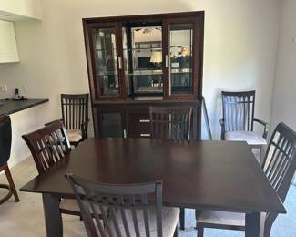 Beautiful contemporary dining set, dark espresso finish, very cohesive and modern. The china cabinet is especially stunning with the mirrored back, glass shelves, built-in lighting, and buffet base. Table with leaf + 6 chairs $400 China cabinet/hutch with buffet $250 As a complete dining room set - $550 This set matches the entertainment wall unit in walnut finish , and I have posted that seperately, if intereted in the full set I will offer $750 for it all.