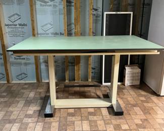 $150  a large professional drafting/draftsman table with a green cutting mat surface, metal adjustable frame, and casters. Big and heavy but very functional.  Needs to be carried upstairs.  Condition: good  Dimensions: [6' x 44"]