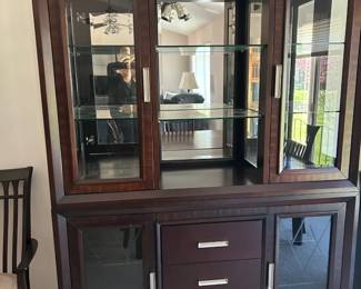 Beautiful contemporary dining set, dark espresso finish, very cohesive and modern. The china cabinet is especially stunning with the mirrored back, glass shelves, built-in lighting, and buffet base. Table with leaf + 6 chairs $400 China cabinet/hutch with buffet $250 As a complete dining room set - $550 This set matches the entertainment wall unit in walnut finish , and I have posted that seperately, if intereted in the full set I will offer $750 for it all.